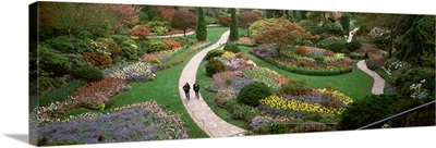 Two people walking in garden, Butchart Gardens, Brentwood Bay, Vancouver Island, British Columbia, Canada