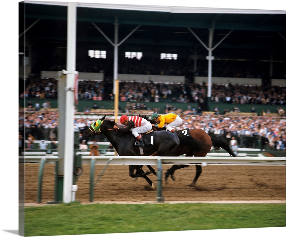 Two race horses and jockeys neck and neck going to the finish line.