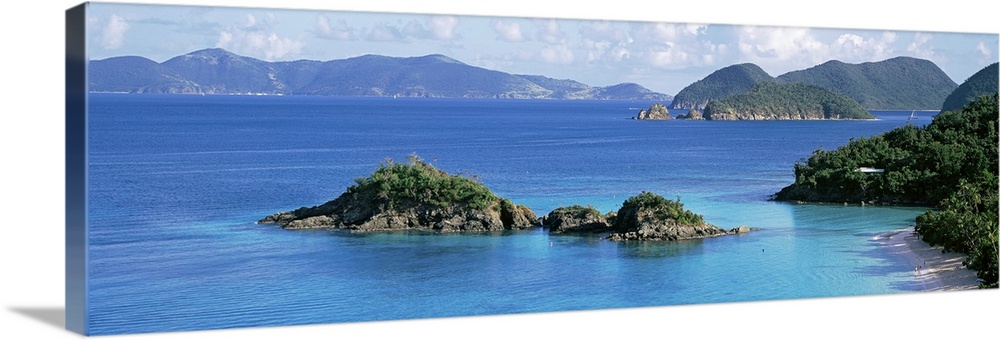 This decorative wall is a panoramic landscape photograph of a small rocky island off the shore of this tropical island.