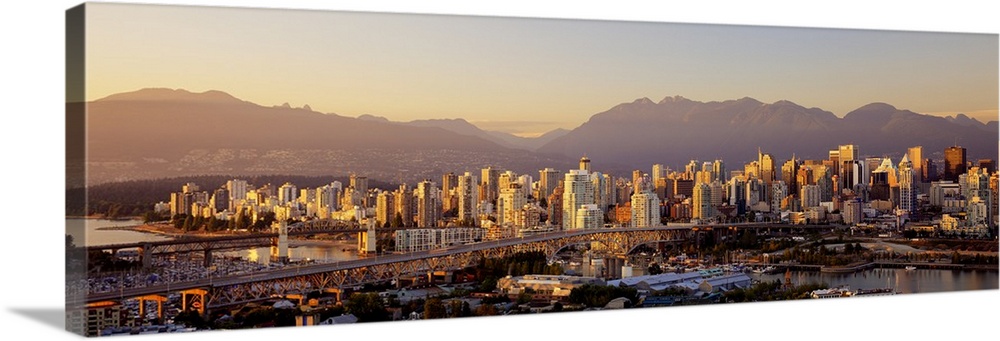 Cityscape panorama of Vancouver Canada with the harbor and bridges in the foreground going to Vancouver Island and the Can...