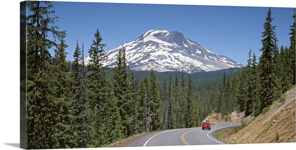 Vehicle moving on a road with South Sister Mountain in background, Oregon