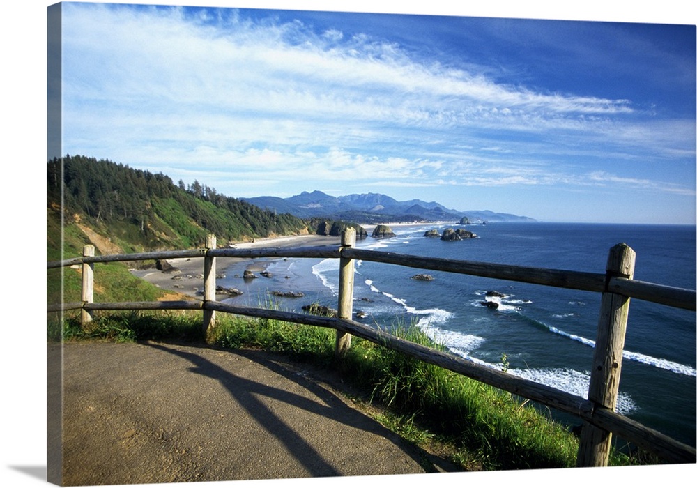 This photograph is taken from a walking trail while looking out at the coast in Oregon with rock formations sitting in the...