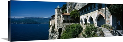 Walkway along a building at a lake, Santa Caterina del Sasso, Lake Maggiore, Piedmont, Italy