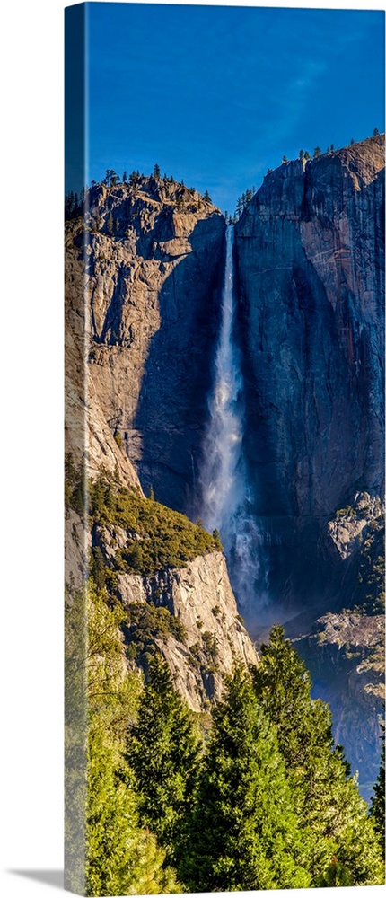 Water falling from rocks in a forest, Yosemite Falls, Yosemite National Park, California, USA.