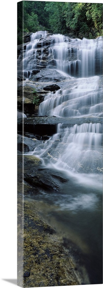 Vertical panoramic of a series of smaller waterfalls making up a large stairway of water pouring down rocks in Nantahala N...