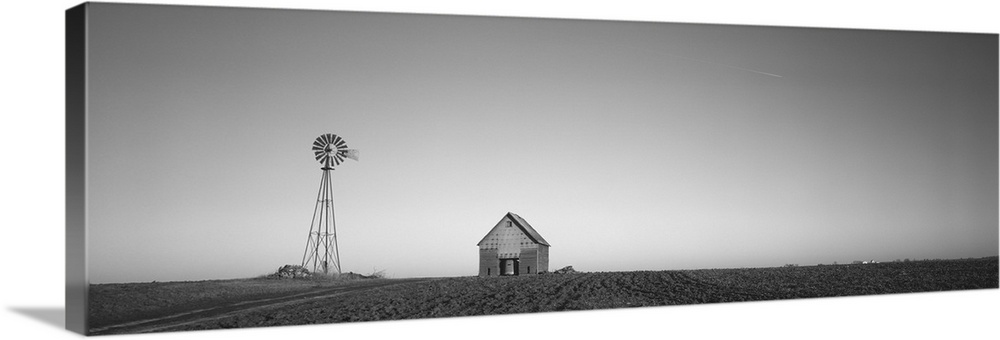 Windmill in a field near a farmhouse, Illinois