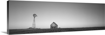 Windmill in a field near a farmhouse, Illinois