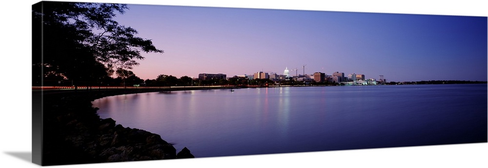 Panoramic photo print of buildings in Madison on the waterfront lit up at dusk.