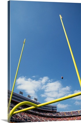 American football flying through the goalposts