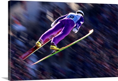 Blurred action of ski jumper flying through the air