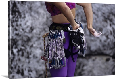 Close up of rock climbing equipment on a female climber