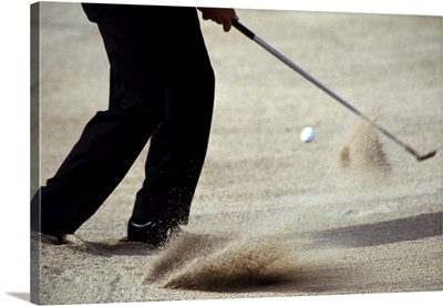 Detail of golfer blasting out of sand trap