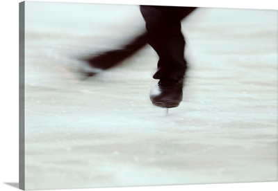 Detail of male figure skater's feet spinning