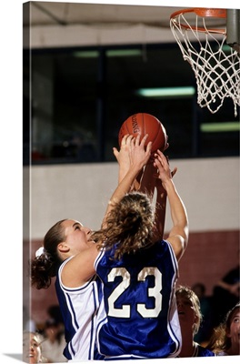 Female High School basketball players in action during a game