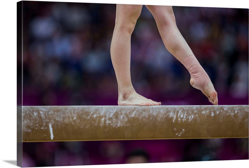 Detail of gymnast  preforming on the balance beam during the women's gymnastics team finals at the 2012 Olympic Summer Gam...