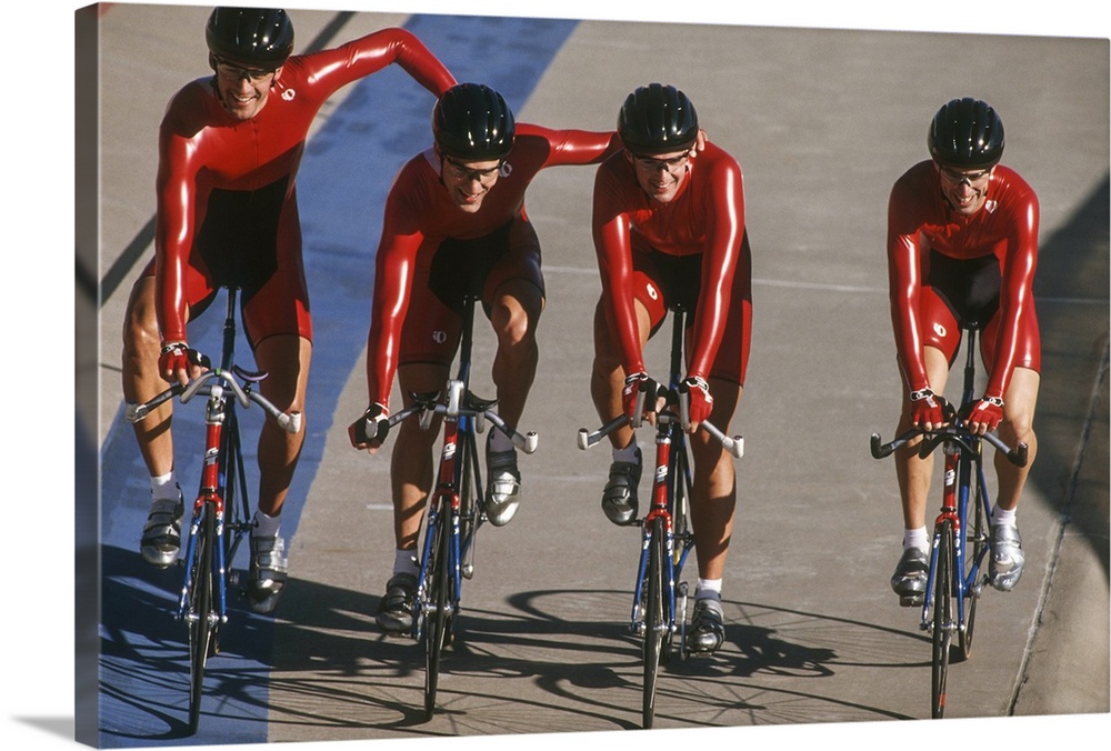 Victorious male cycling team on the velodrome