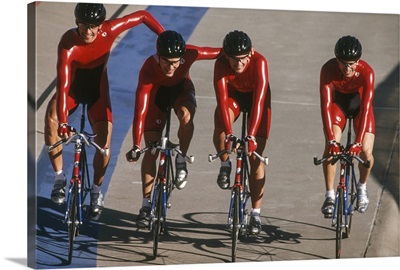 Victorious male cycling team on the velodrome