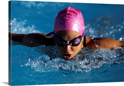 Woman in action during a butterfly swimming race.