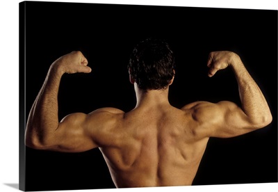 Young adult male posing with arms flexed