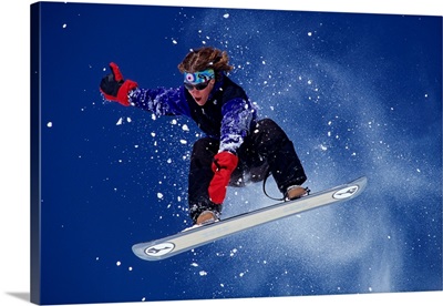 Young male snowboarder in action
