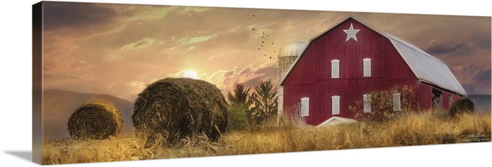 A large red barn in the countryside at sunset.