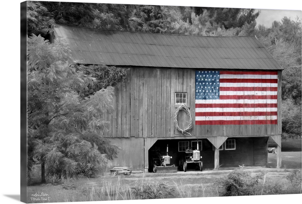 Black and white photo of a barn with an American Flag in color painted on the side.