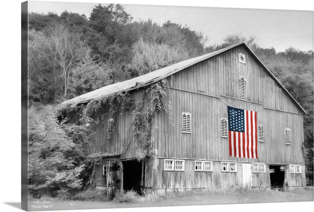 Black and white photo of a barn with an American Flag in color hanging on the side.