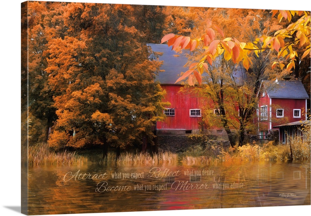 Red barn surrounded by fall foliage at the edge of a pond.