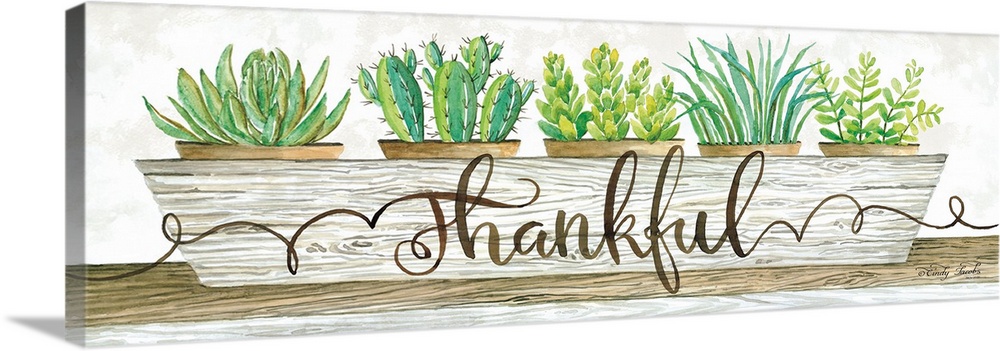 The word, thankful, is placed over a planter filled with bright green succulents and cacti.