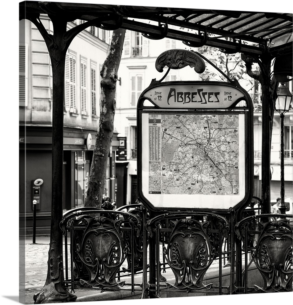 A black and white photograph of the Abbesses subway station sign in Paris.