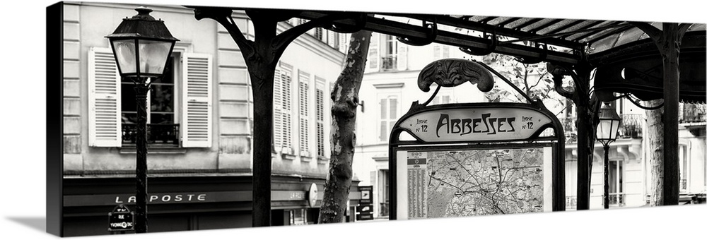 A black and white photograph of the Abbesses subway station sign in Paris.