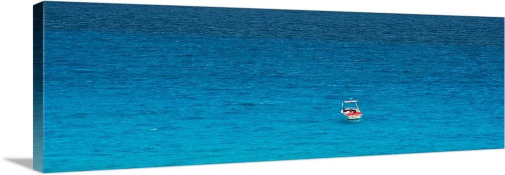 Panoramic photograph of a single boat floating in the bright blue ocean. From the Viva Mexico Panoramic Collection.