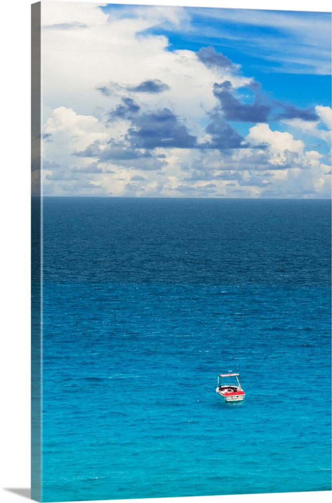 Photograph of a single boat on the clear blue sea. From the Viva Mexico Collection.