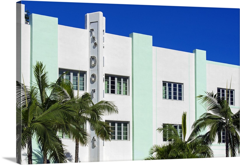 Palm trees frame an Art Deco style building in Miami, Florida.