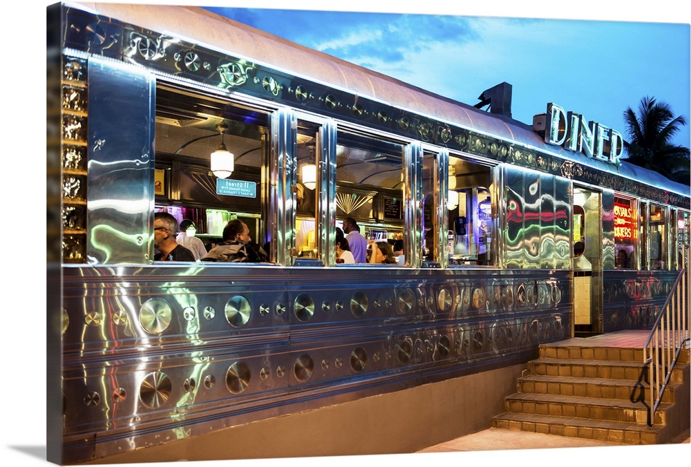 Photo of an art deco style diner in Florida, lit with neon lights at dusk.