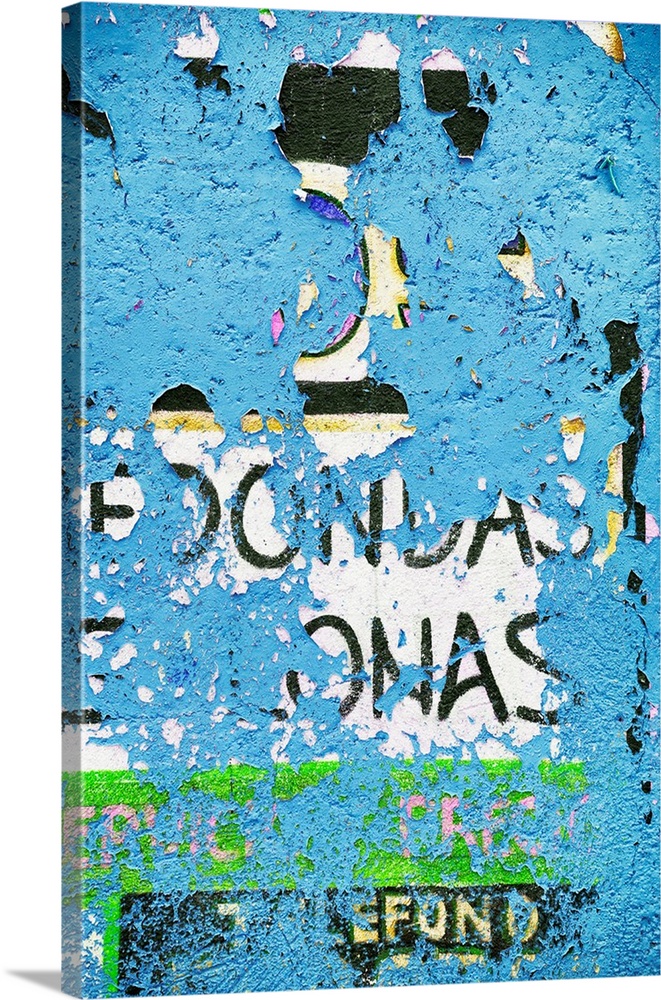 Photograph of peeling blue street art paint, revealing old text. From the Viva Mexico Collection.