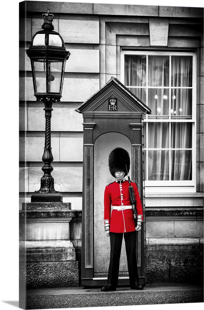 Photo with selective color of a guard in traditional uniform at Buckingham Palace in London, England.