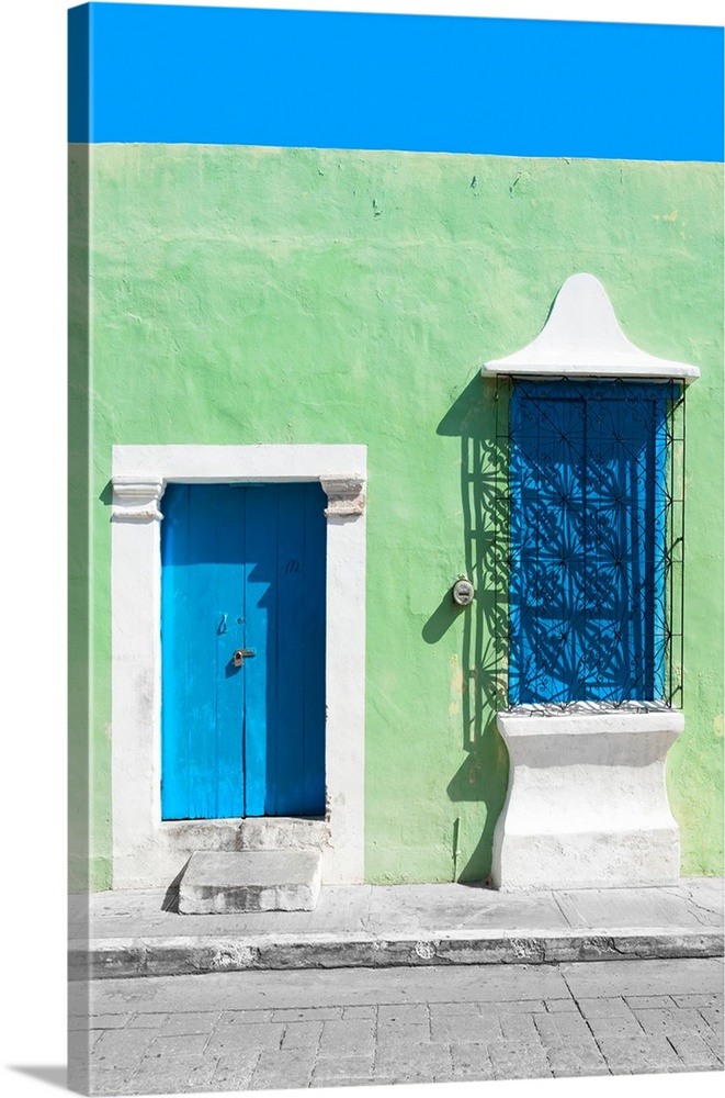 Photograph of a green exterior wall with a blue door and window in Campeche, Mexico. From the Viva Mexico Collection.