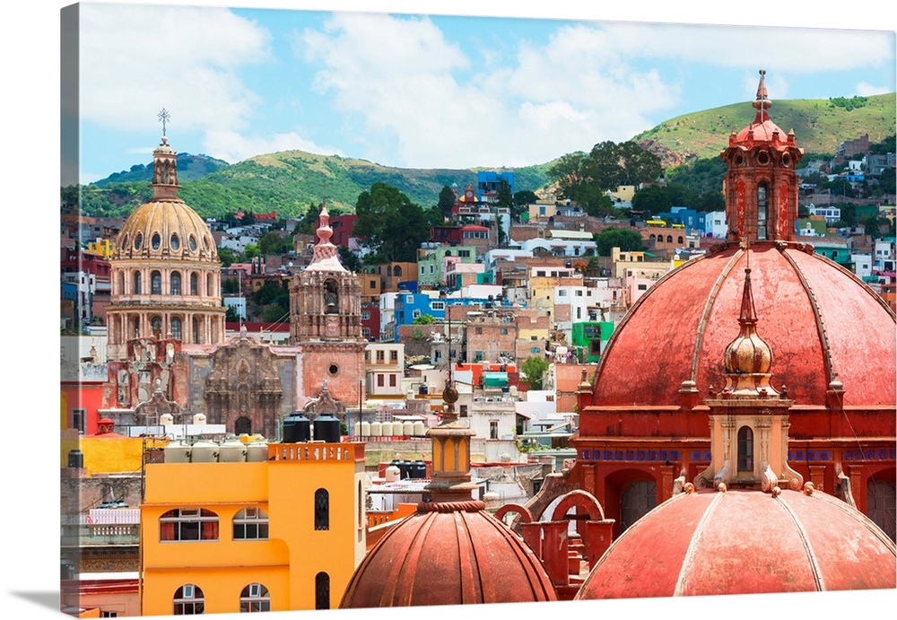 Cityscape photograph of colorful buildings and several church domes in Guanajuato, Mexico. From the Viva Mexico Collection.