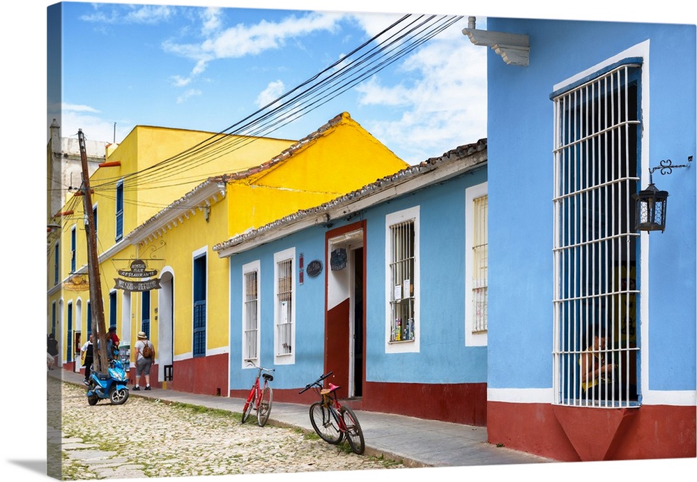 Colorful blue, yellow, and red facade with bikes parked out front in downtown Havana.