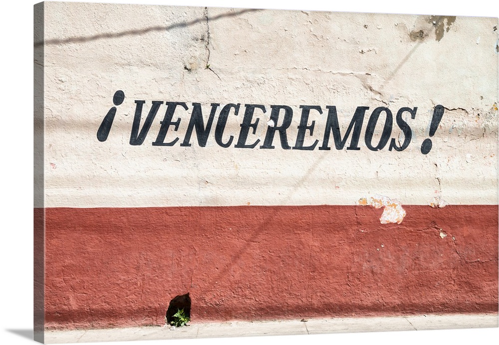 "iVenceremos!" painted on to a Havana facade.