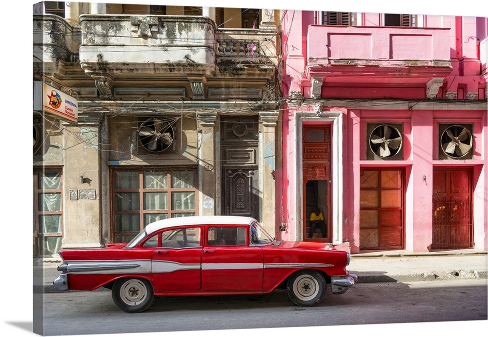 Photograph of a red vintage car with white details parked in the street, Havana, Cuba