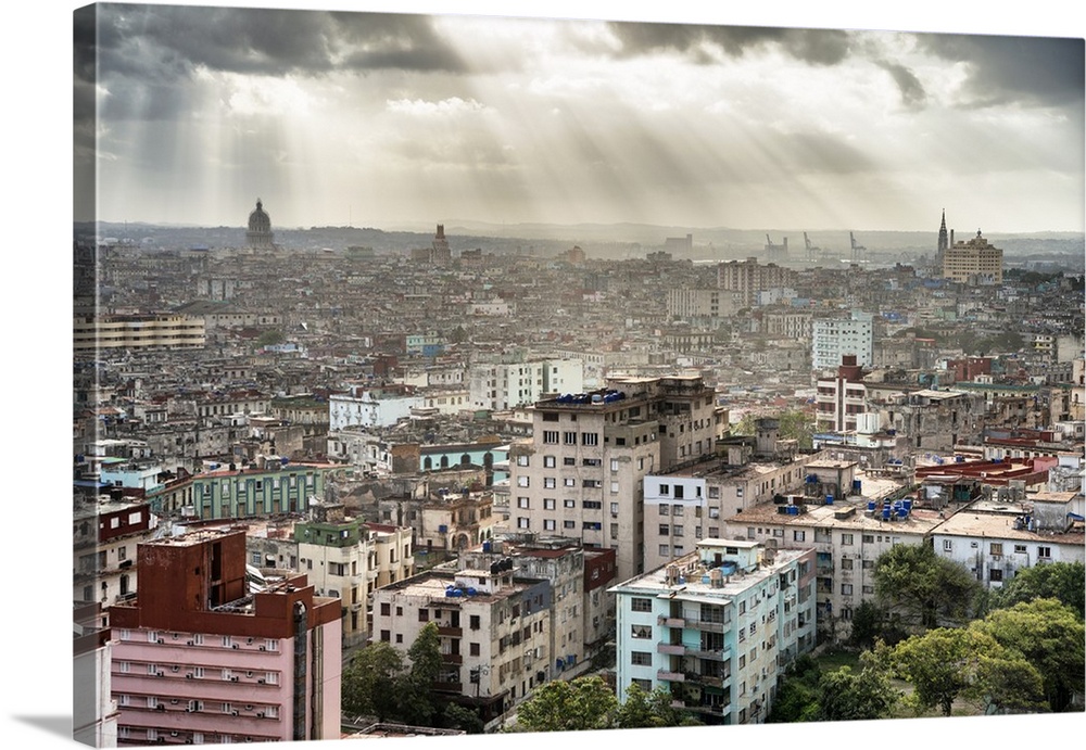 Beautiful photograph of the sun beaming through the clouds over the city of Havana.