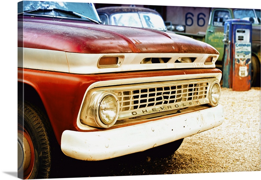 The grille and headlights of a classic Chevy car at a gas station on Route 66.
