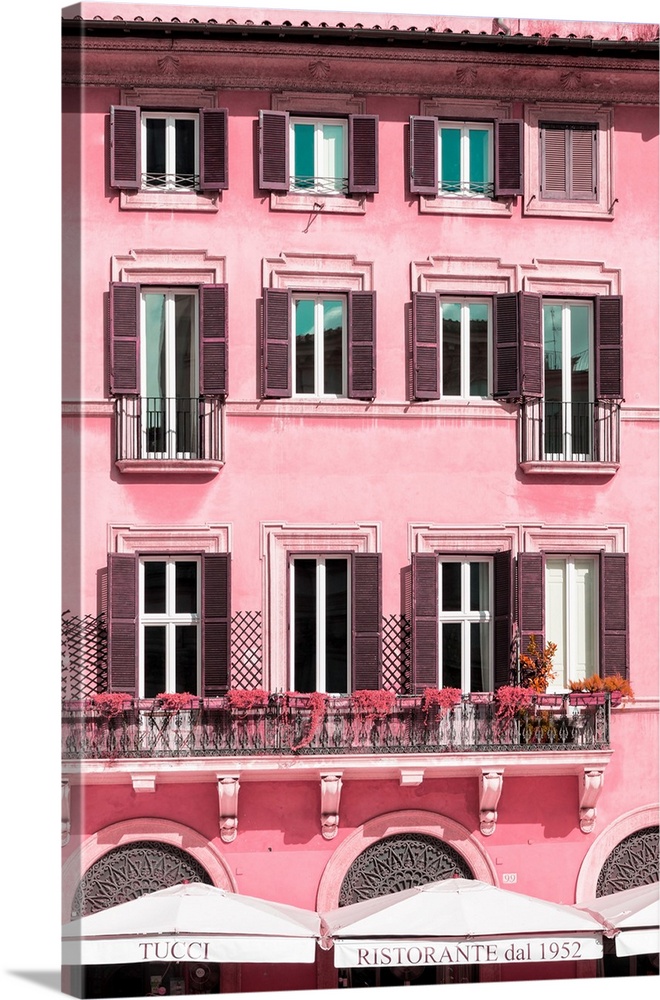 It's a pink facade of a building in the city of Rome in Italy.