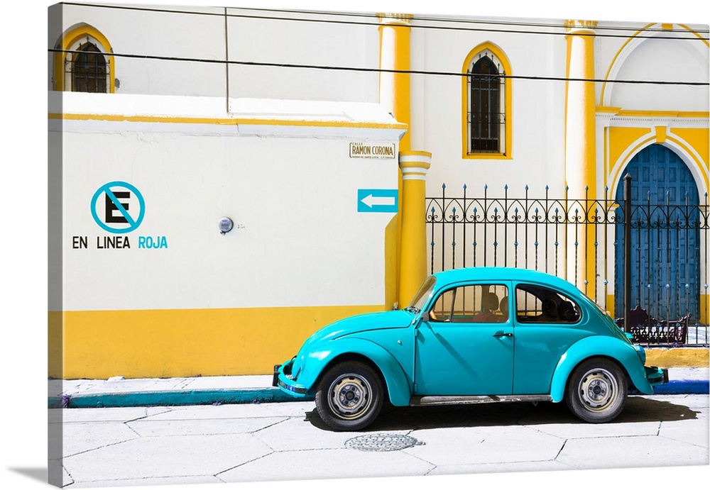 Photograph of a Volkswagen Beetle parked in front of a yellow and white building. From the Viva Mexico Collection.