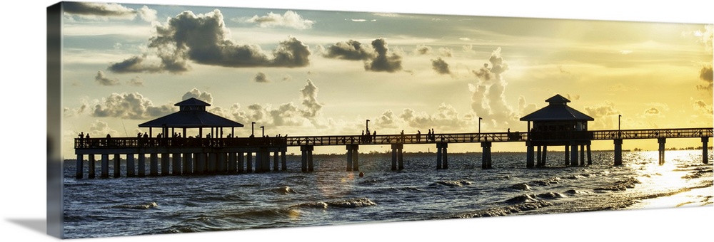 Panoramic view of a silhouetted fishing pier at sundown in Florida.