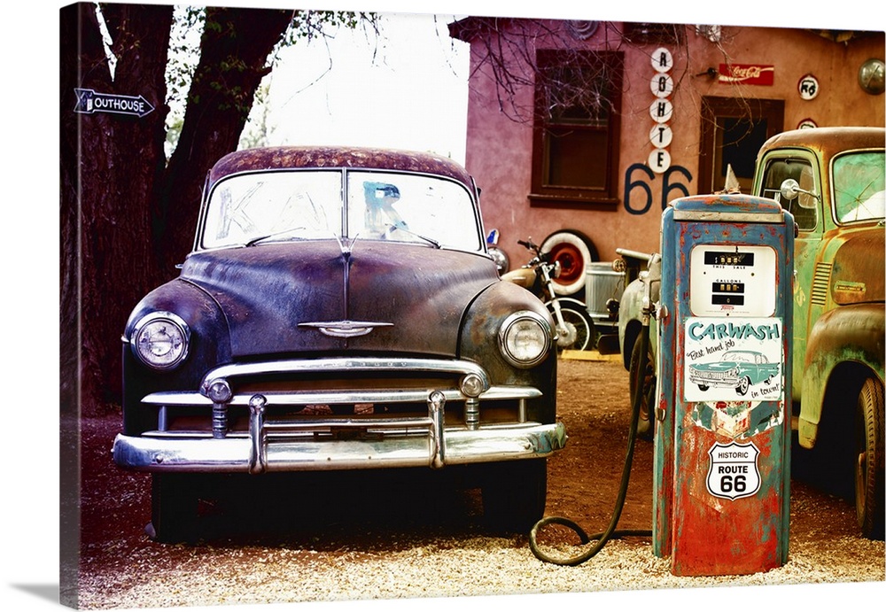 A classic car fills up at a vintage fueling station on Route 66.