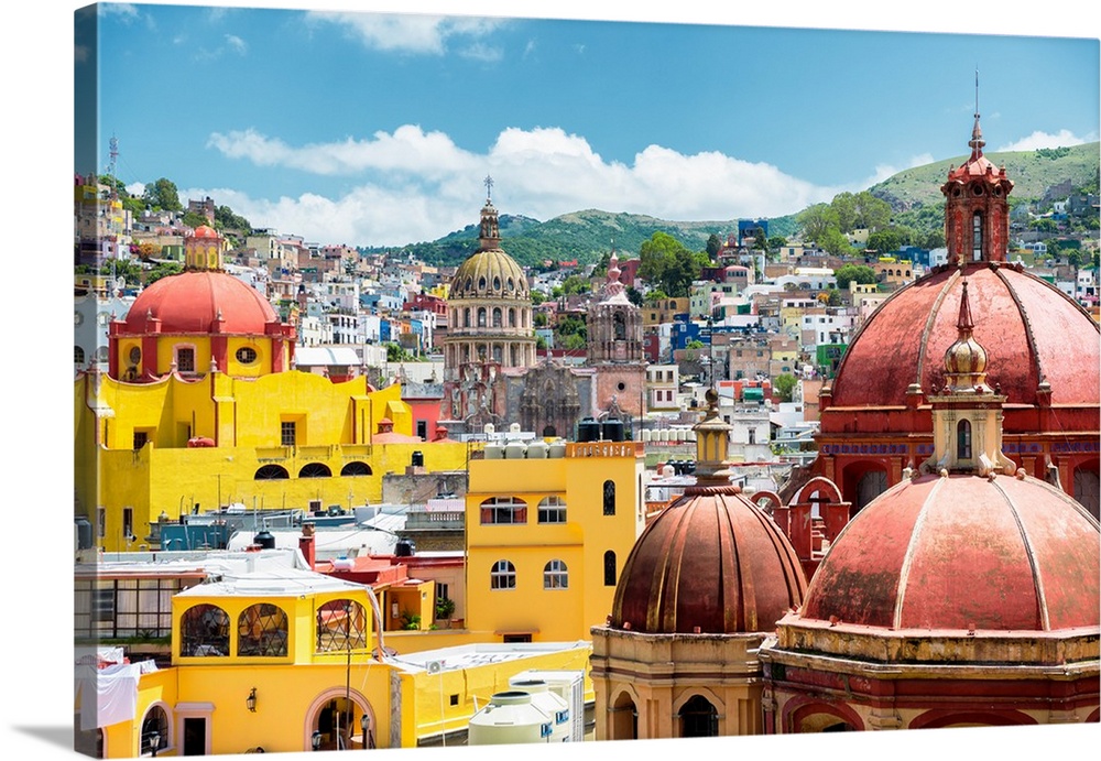 Photograph of a cityscape in Guanajuato, Mexico, highlighting the colorful buildings and church domes. From the Viva Mexic...