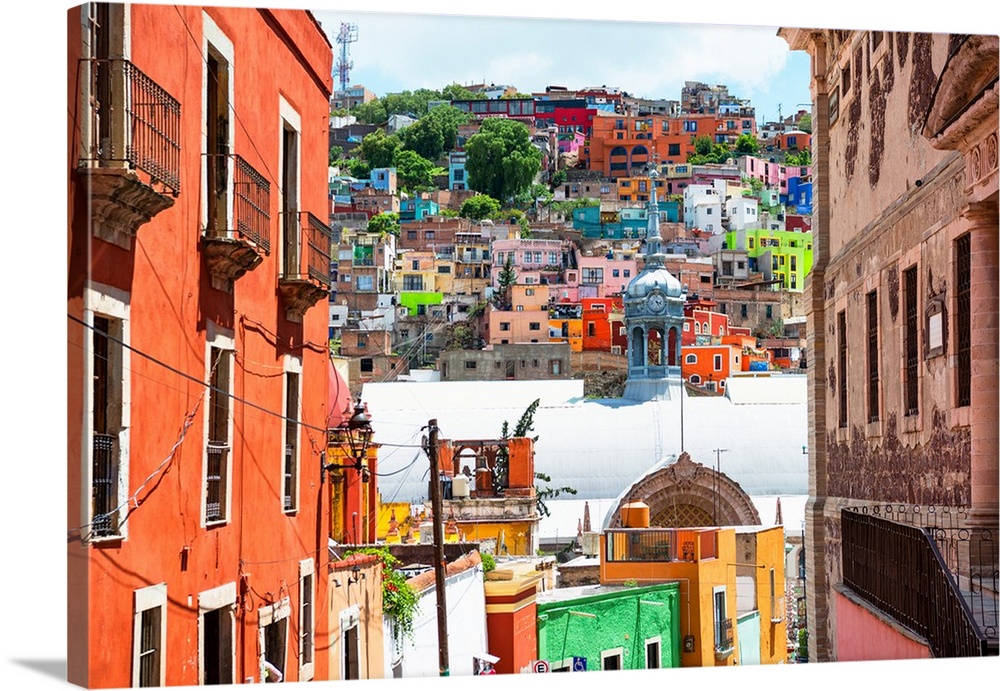 Photograph of a Guanajuato, Mexico, cityscape displaying colorful buildings, homes, and church domes. From the Viva Mexico...